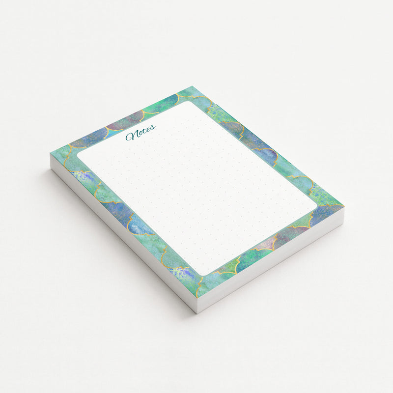 Gilded Mosaic memo pad shown at an angle with a jewel-toned turquoise and blue border, gold-colored geometric detailing, and subtly dotted writing area.