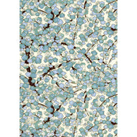 Japanese Chiyogami paper with dense turquoise, powder-blue, cream, and periwinkle blossoms on dark brown branches against an ivory ground.