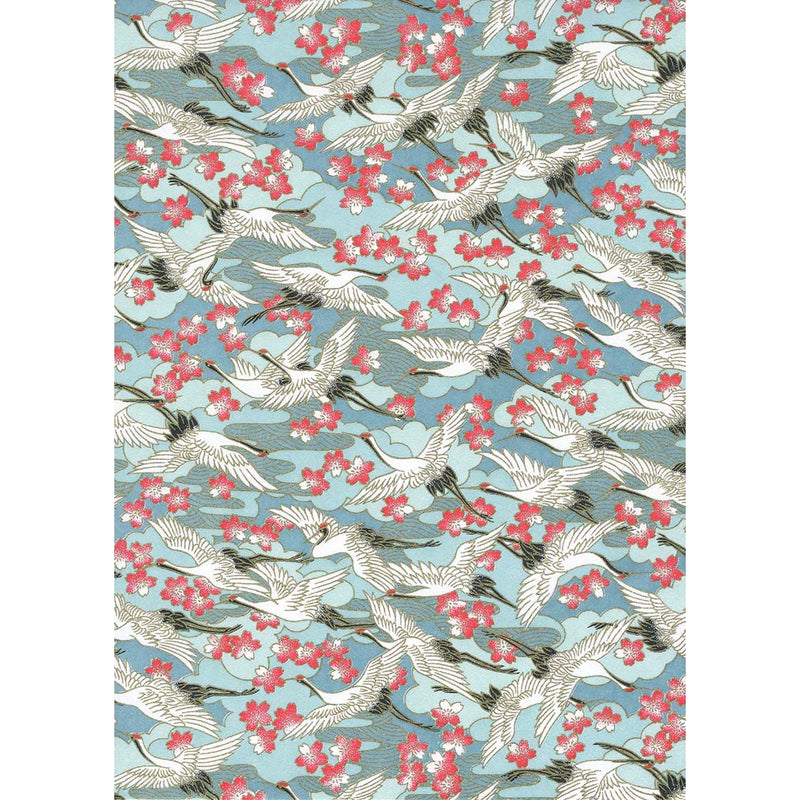 Japanese Chiyogami paper with ivory cranes in flight, coral and white blossoms, and layered blue forms on a turquoise background.