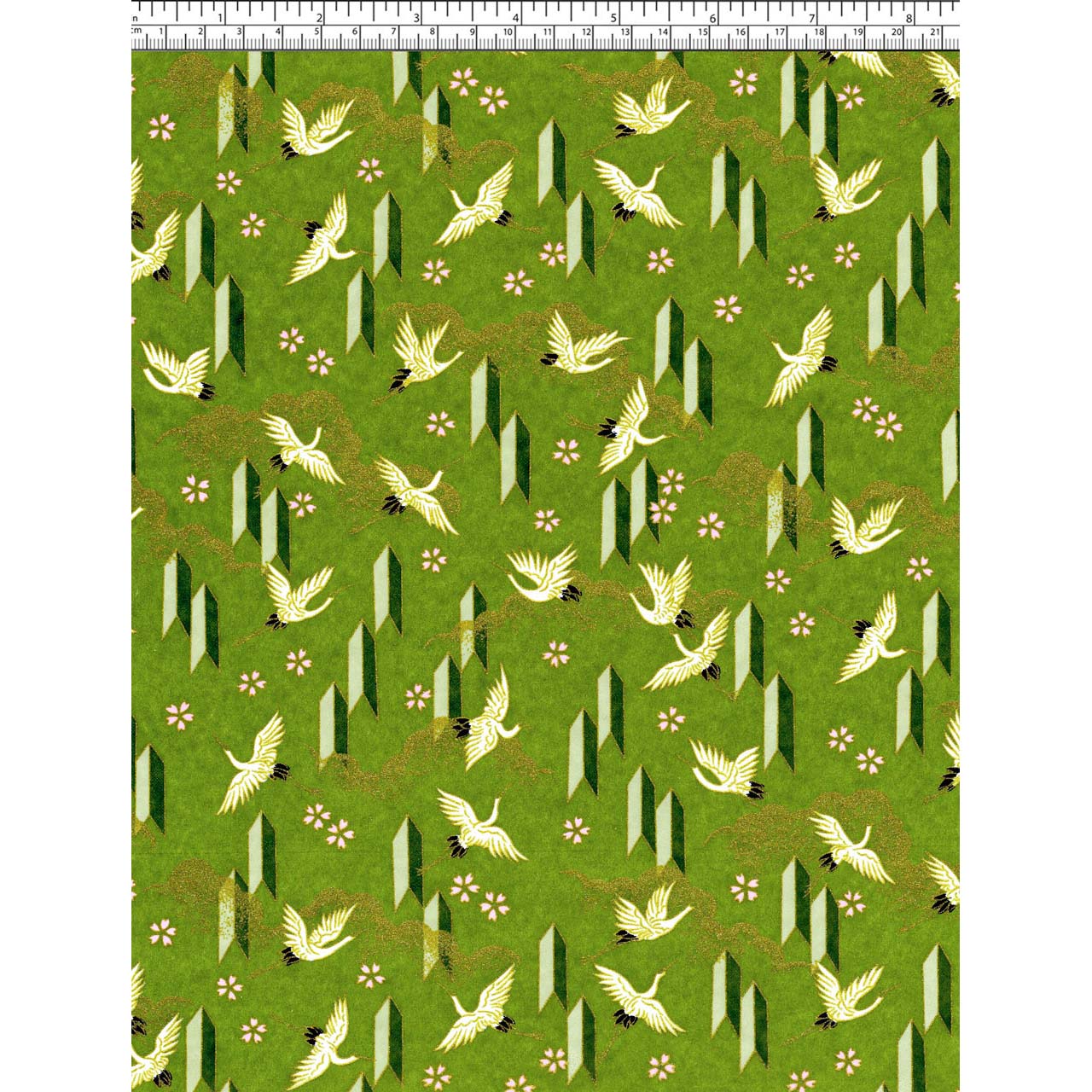 Close-up of hand silk-screen printed Chiyogami paper showing ivory cranes in flight, small blossoms, and angular motifs on green.