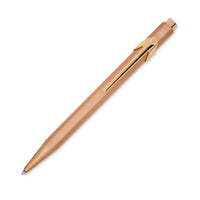 Red pen with black accents on a white background