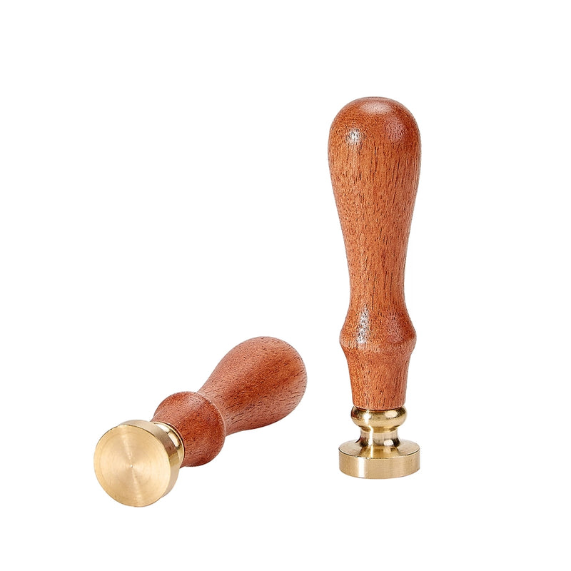 Two wooden stamp handles with gold metal ends on a white background