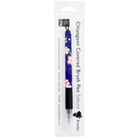 Sakura bristle brush pen wrapped in decorative blue floral Japanese Chiyogami paper, shown in its clear retail packaging.