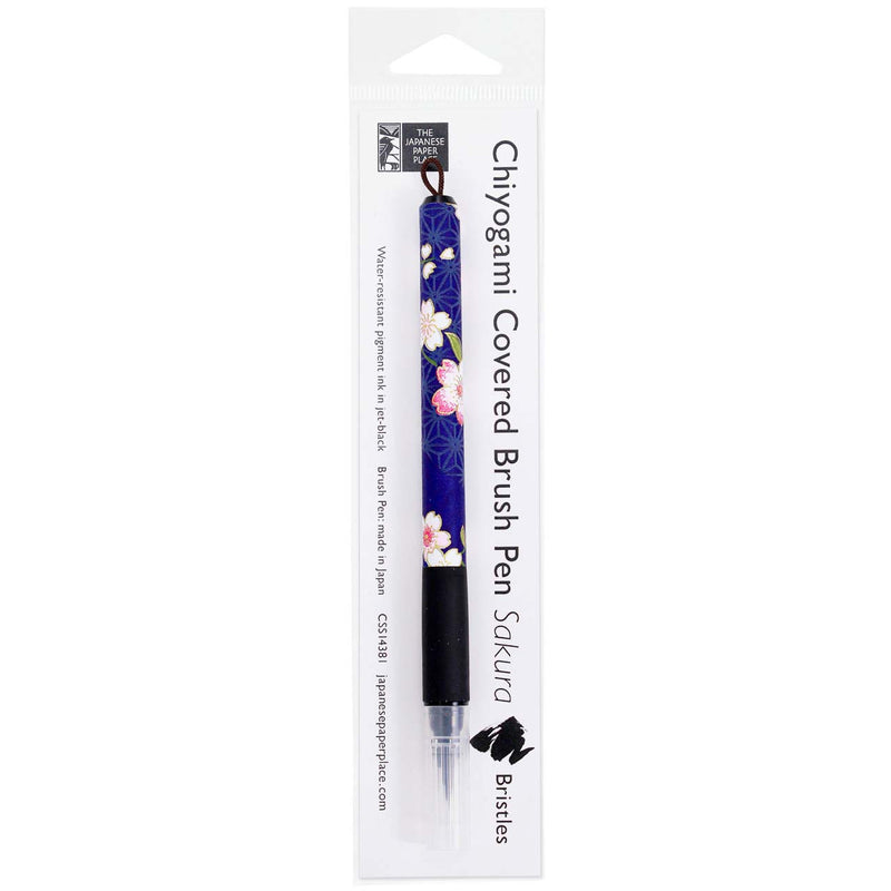 Sakura bristle brush pen wrapped in decorative blue floral Japanese Chiyogami paper, shown in its clear retail packaging.
