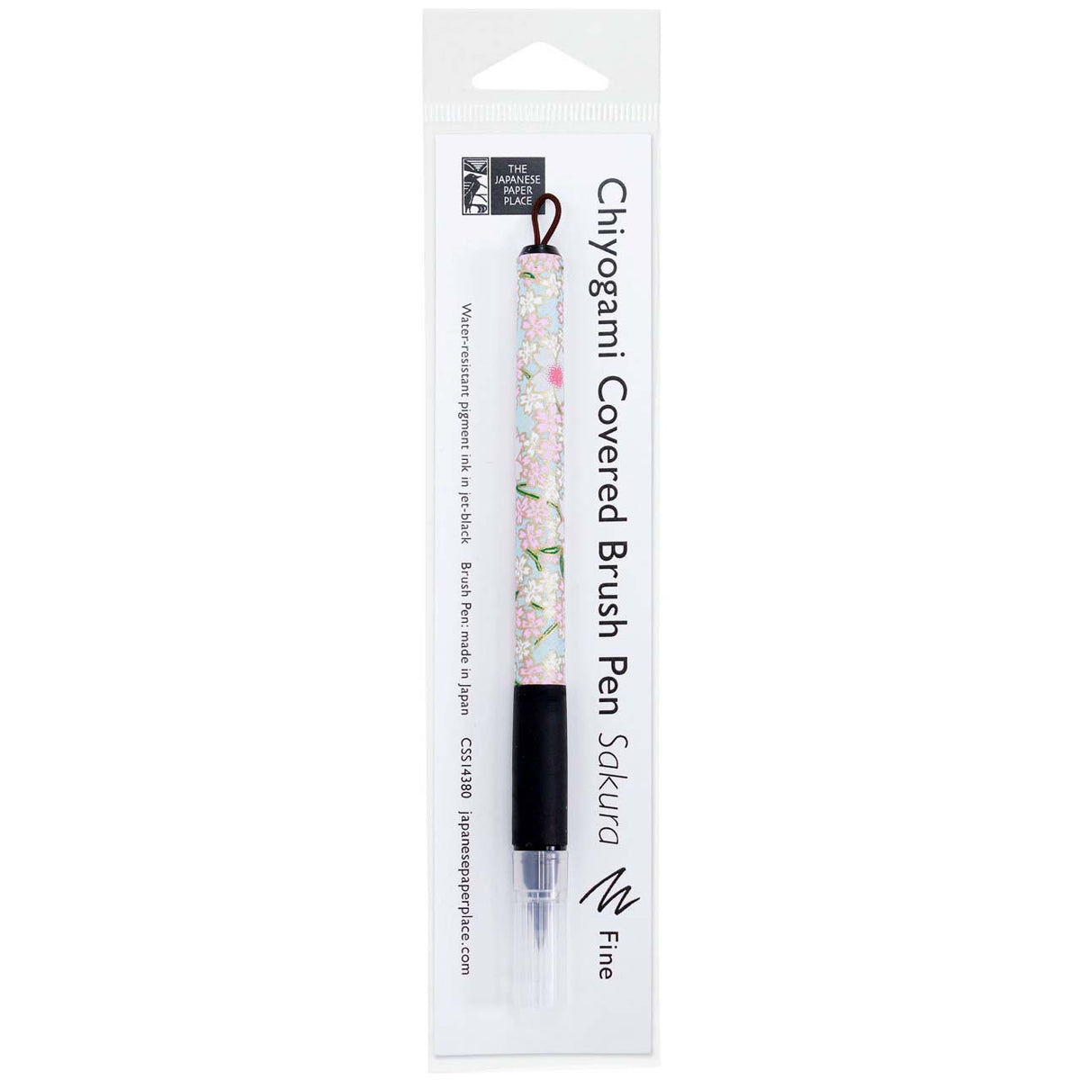 A Sakura fine brush pen wrapped in decorative Japanese Chiyogami paper with black rubber grips and capped felt tips.