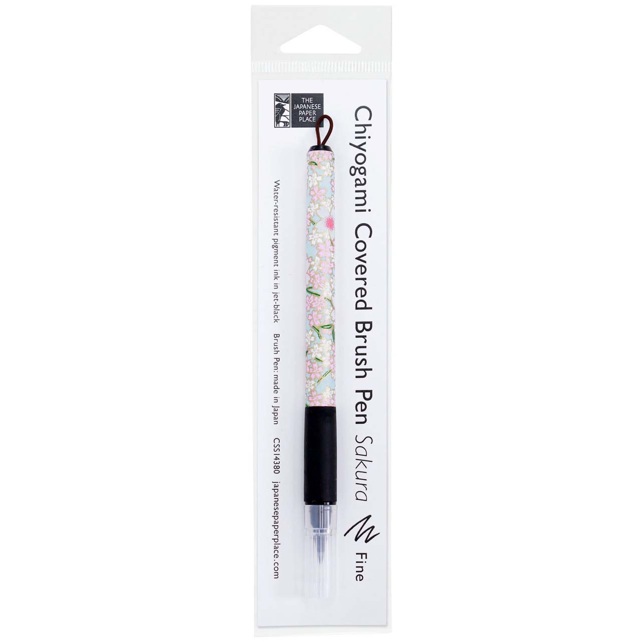 A Sakura fine brush pen wrapped in decorative Japanese Chiyogami paper with black rubber grips and capped felt tips.