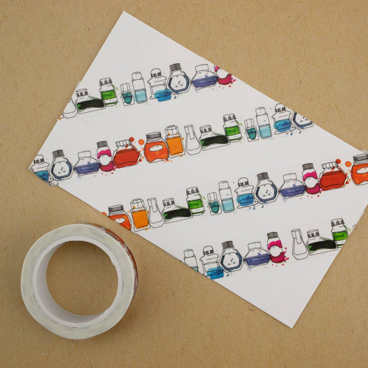 Sheet of paper with colorful ink bottle illustrations on a brown background