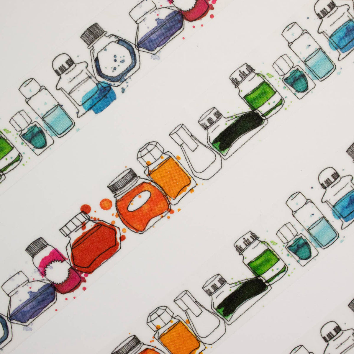 Pattern of colorful ink bottles on a white background